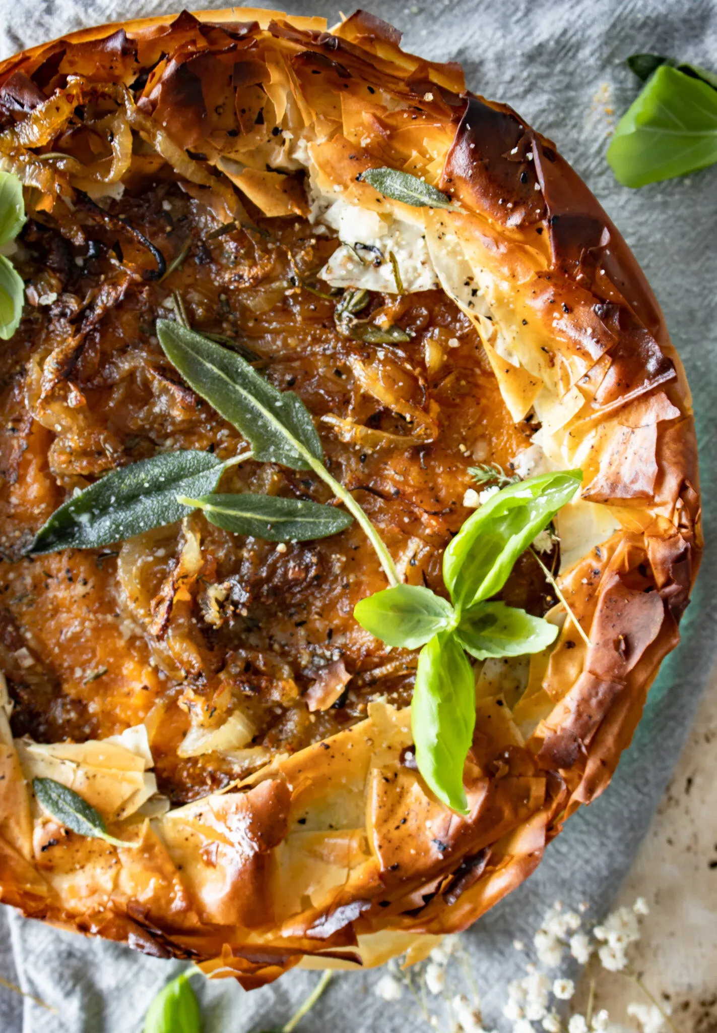 Close-up overhead of the golden phyllo crust of the sweet potato, spinach and caramelized onion phyllo pie