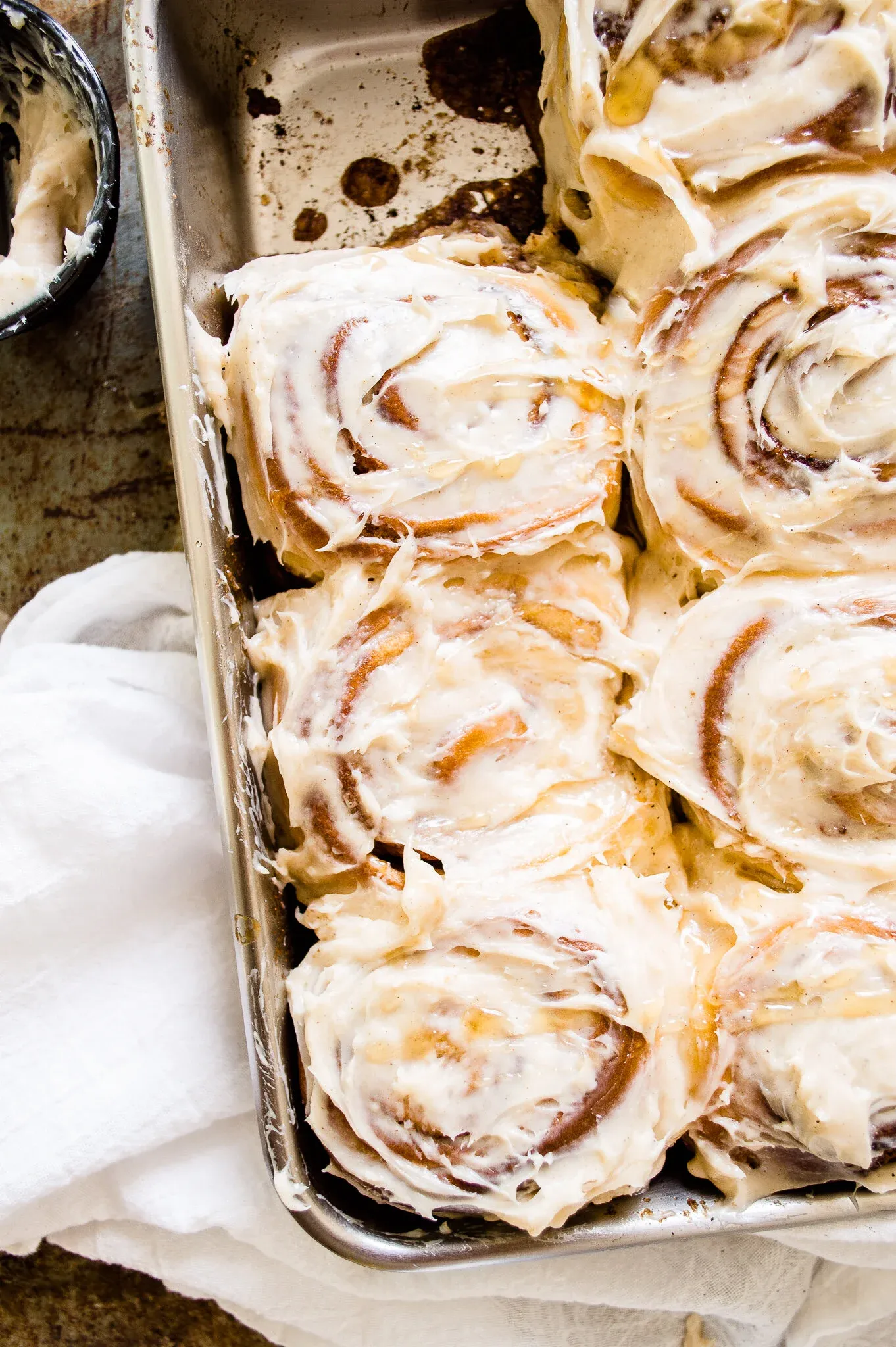Slightly angled overhead close-up of Brown Butter Cinnamon Rolls in the silver pan