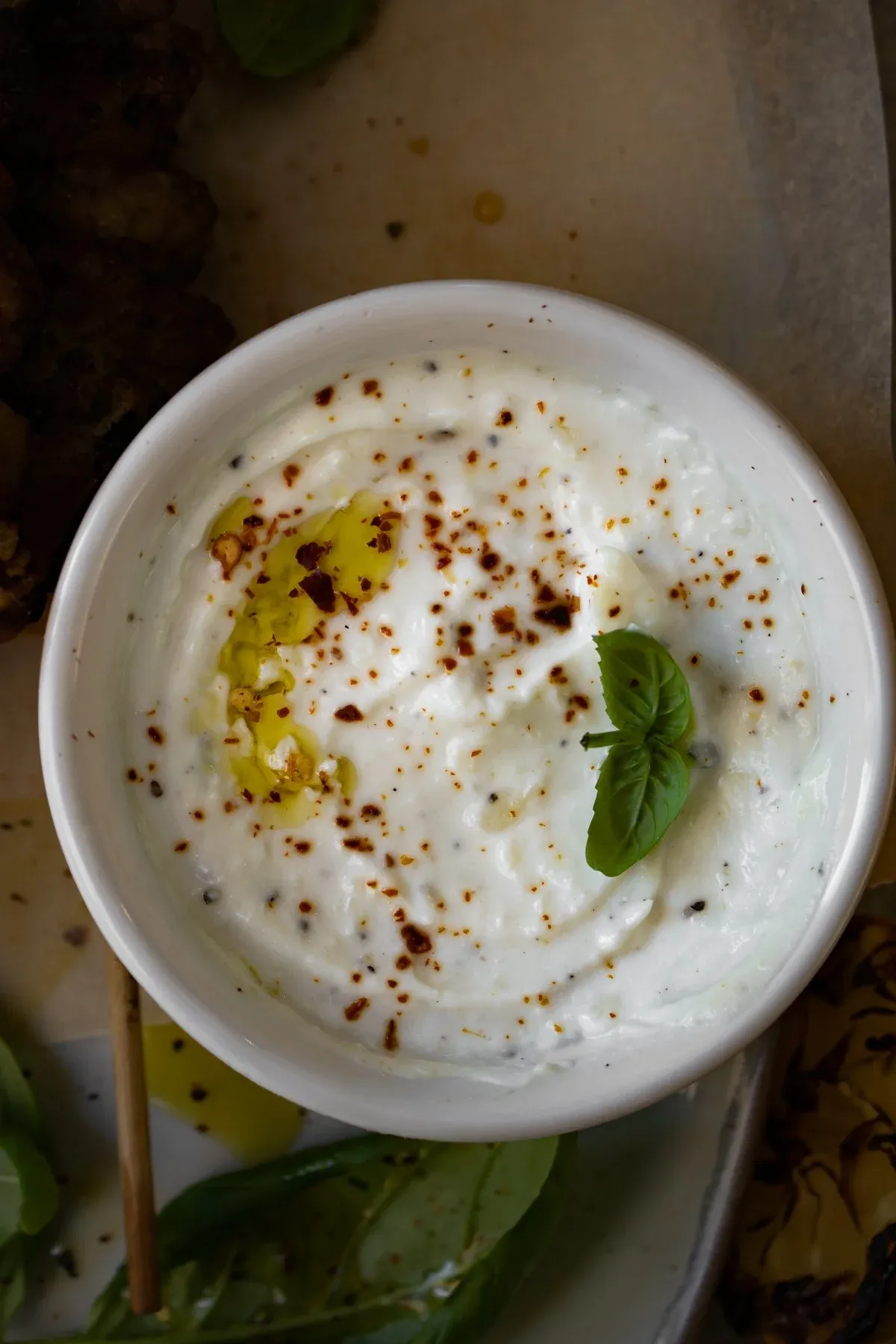 Close-up overhead of the garlicky whipped ricotta dipping bowl — smooth