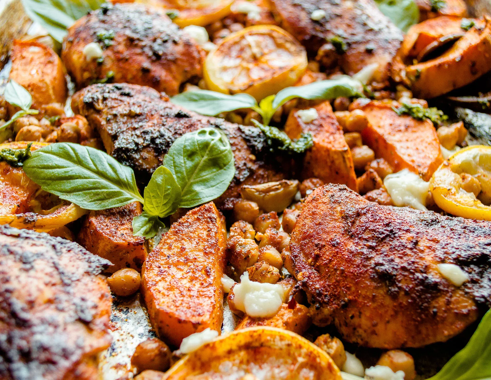 Close-up shot of the Sheet Pan Harissa Chicken filling the frame