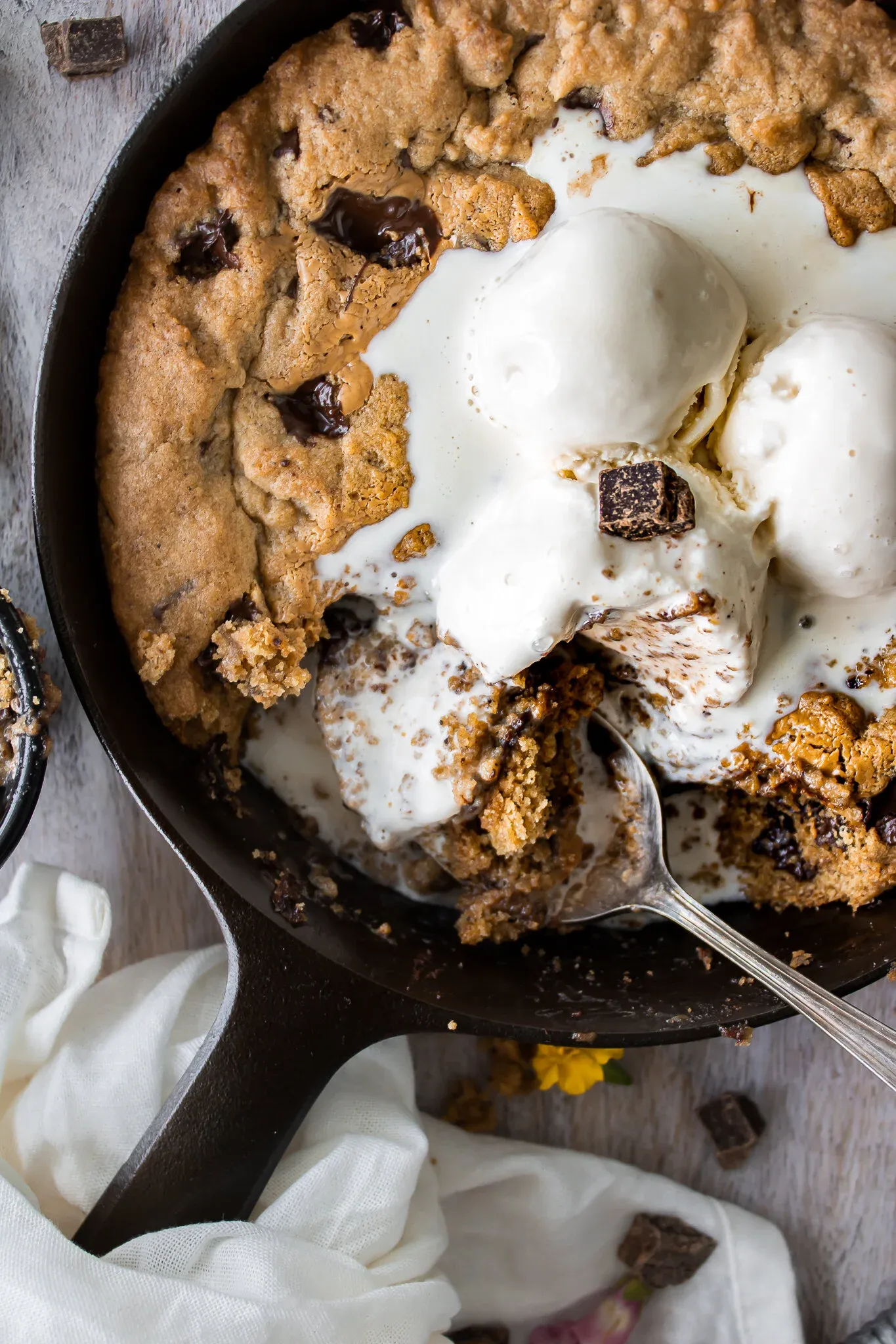 Close angled overhead view of Skillet Dark Chocolate Chip Espresso Cookie in a black cast iron skillet