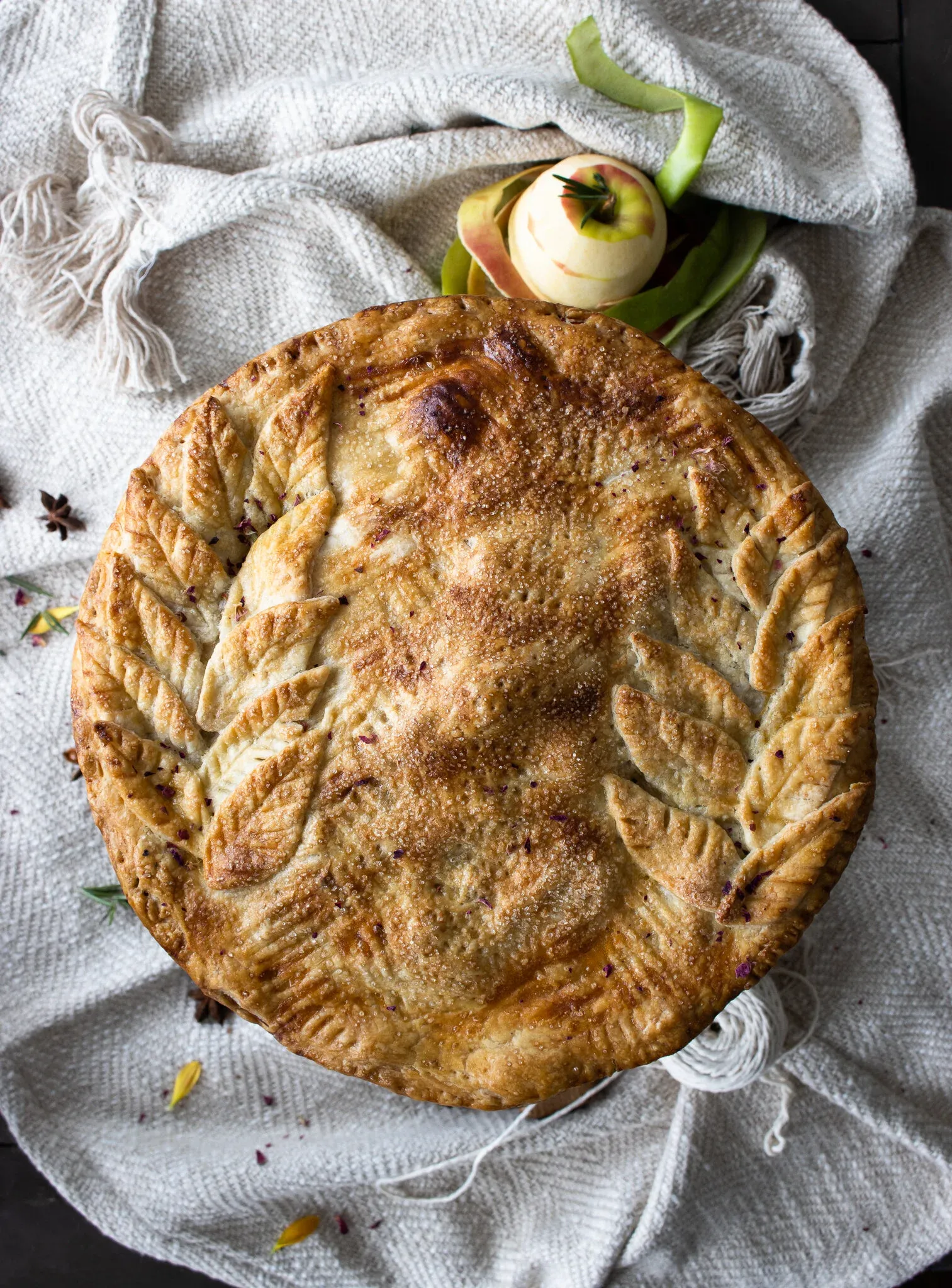 Overhead shot of the Classic Apple Pie centered on a soft cream woven linen blanket