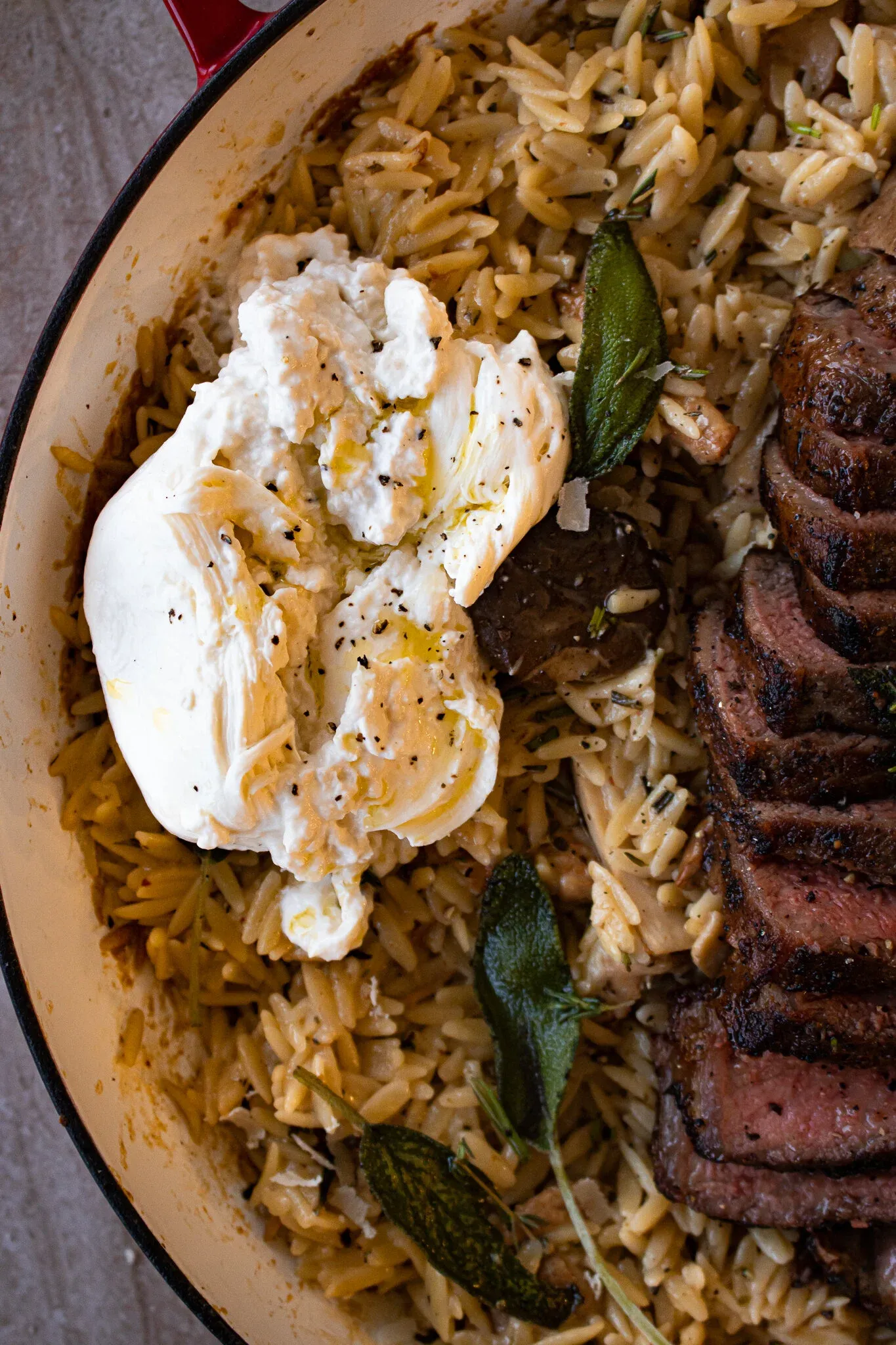The burrata portion of the Brown Butter Orzo with Mushrooms, Burrata, and Steak pan