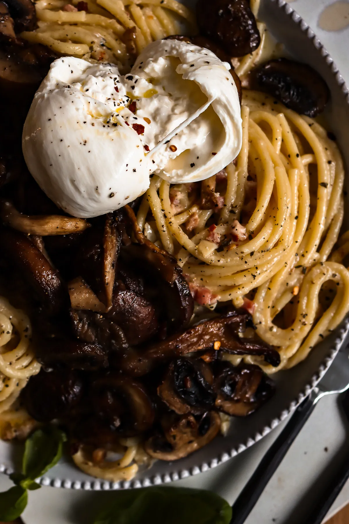 White Wine Pasta with Roasted Mushroom in a large white beaded-rim bowl on a white tray