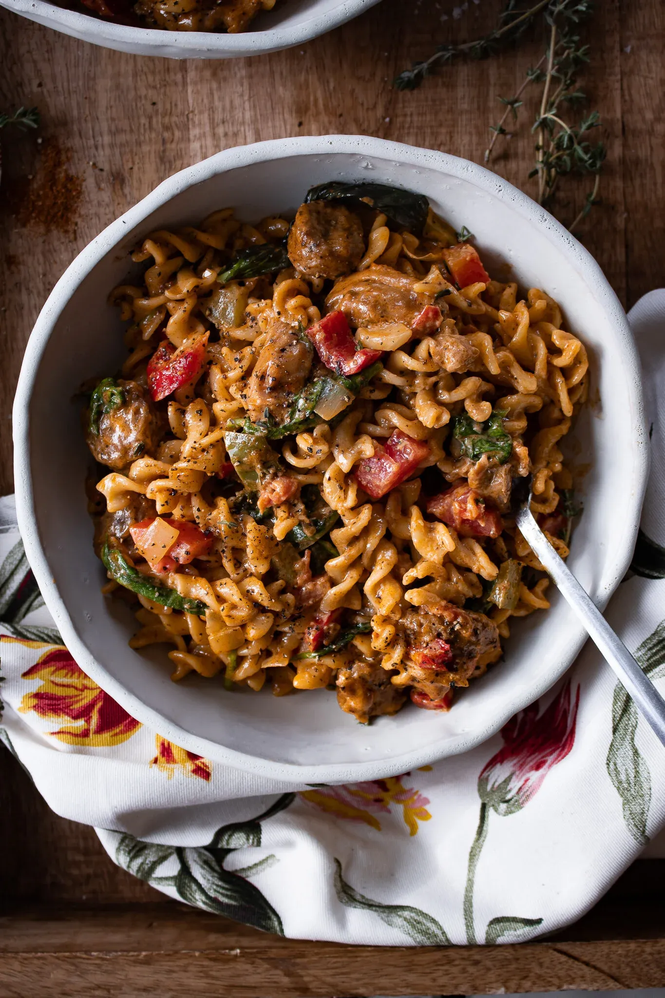 Overhead view of a white ceramic bowl of Cajun Chicken and Sausage Pasta
