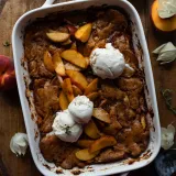 Overhead view of Brown Butter Peach Cobbler in a white rectangular handled baking dish