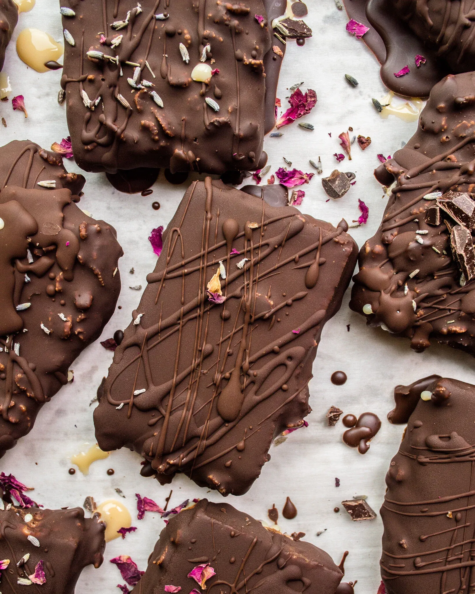 Overhead flat-lay of multiple No-Bake Dulce De Leche Peanut Butter Crunch Bars scattered on white parchment paper