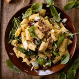 30 Minute Basil Pasta with Sun-Dried Tomatoes in a terracotta ceramic bowl